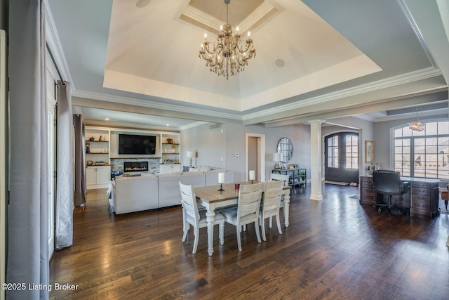 dining room featuring crown molding, a fireplace, french doors, a raised ceiling, and dark hardwood / wood-style flooring