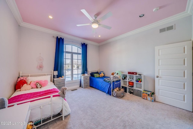 bedroom with ceiling fan, ornamental molding, and carpet floors