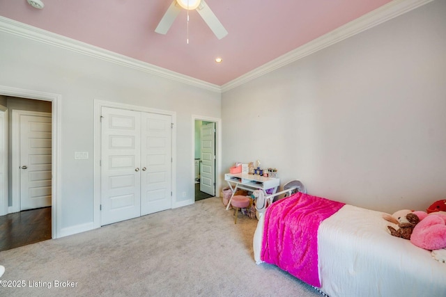 carpeted bedroom with a closet, ceiling fan, and ornamental molding