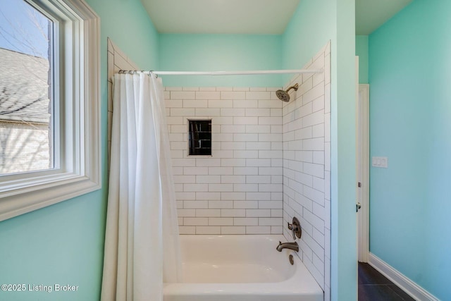 bathroom featuring shower / bath combo with shower curtain and tile patterned flooring