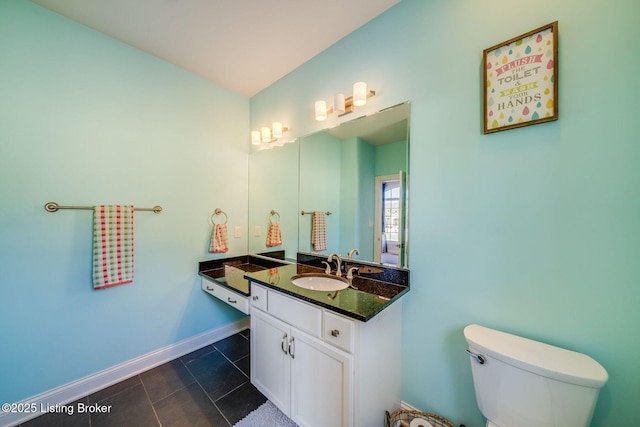 bathroom with vanity, toilet, and tile patterned floors