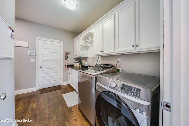 laundry area featuring washer and dryer, cabinets, and dark hardwood / wood-style floors