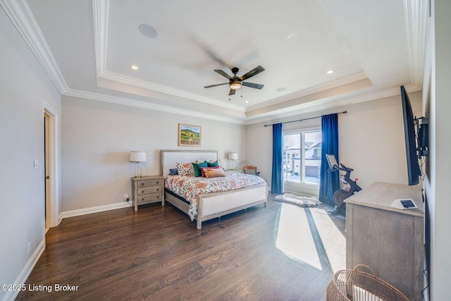 bedroom featuring ornamental molding, dark wood-type flooring, ceiling fan, and a raised ceiling