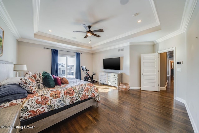 bedroom with ceiling fan, crown molding, dark hardwood / wood-style floors, and a raised ceiling