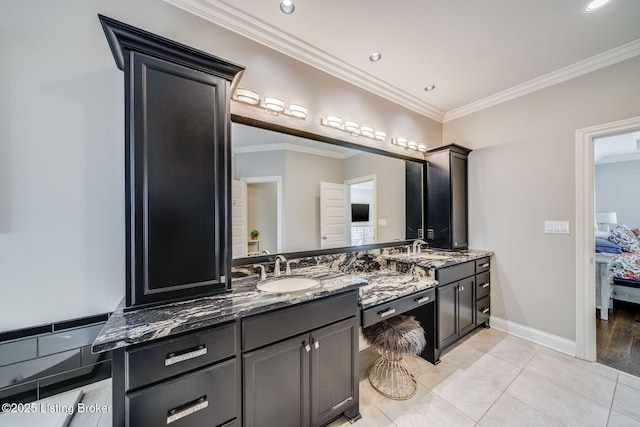 bathroom with crown molding, tile patterned flooring, and vanity