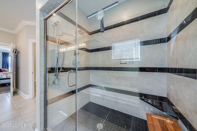 bathroom with a shower with shower door, crown molding, and tile patterned flooring