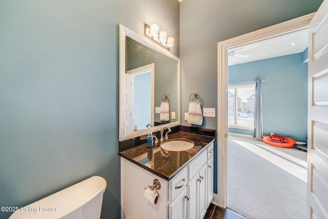 bathroom featuring vanity and toilet