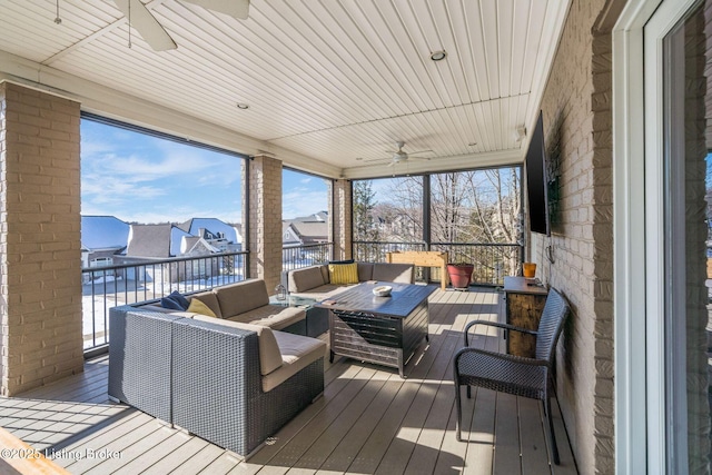 sunroom featuring ceiling fan