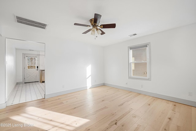 spare room with light hardwood / wood-style flooring and ceiling fan