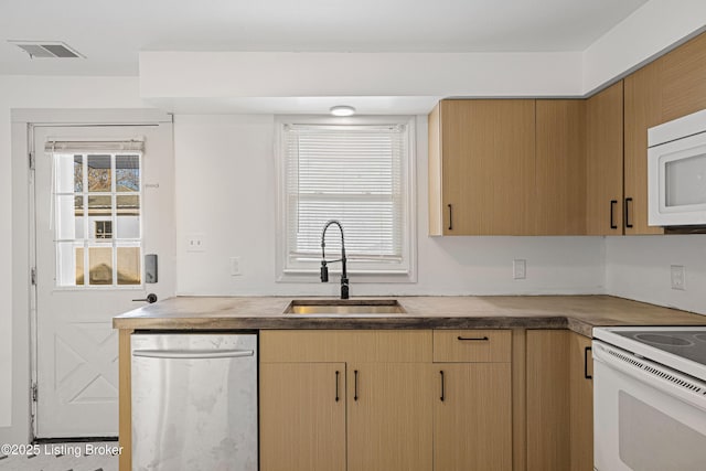 kitchen featuring sink and white appliances