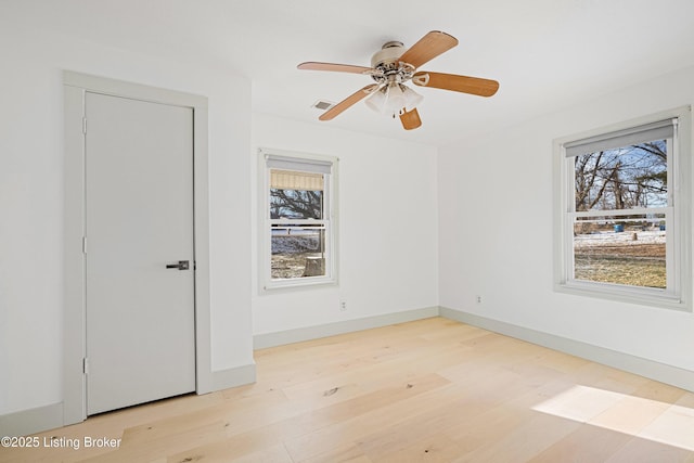 spare room with ceiling fan and light hardwood / wood-style floors