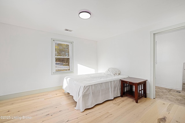 bedroom with light wood-type flooring