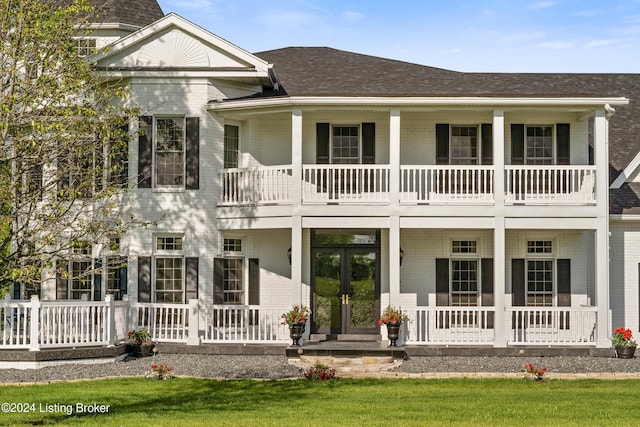 rear view of house featuring a porch and french doors