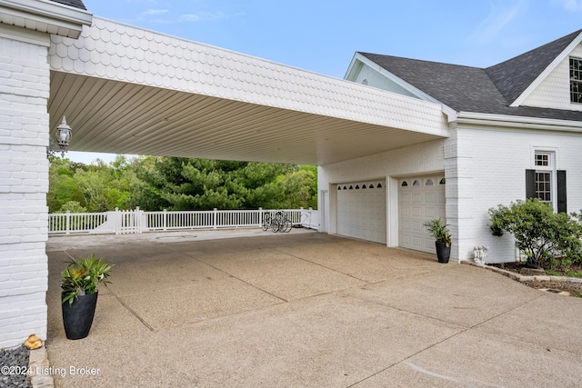 view of side of home featuring a garage and a carport