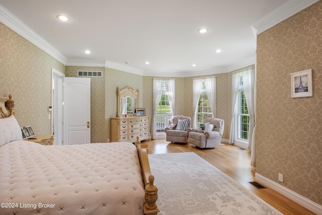 bedroom with ornamental molding and light wood-type flooring