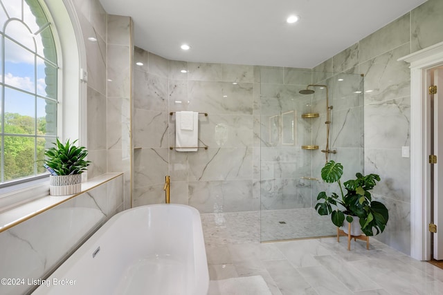 bathroom featuring tile walls and plus walk in shower