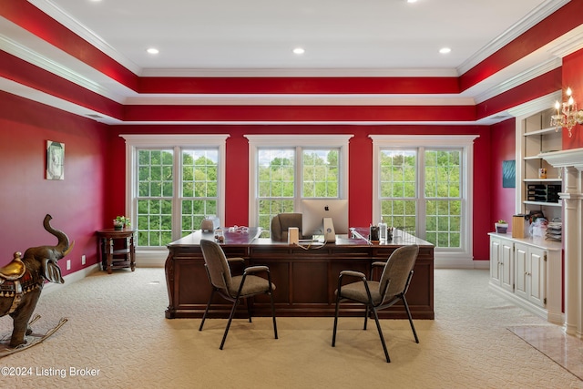 carpeted home office with ornamental molding, a healthy amount of sunlight, and built in features