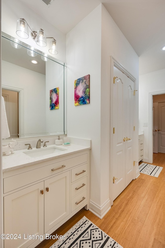 bathroom with hardwood / wood-style flooring and vanity