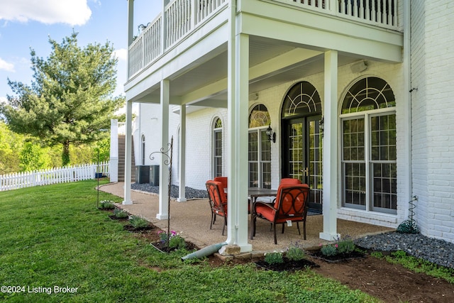 exterior space featuring a balcony and a lawn