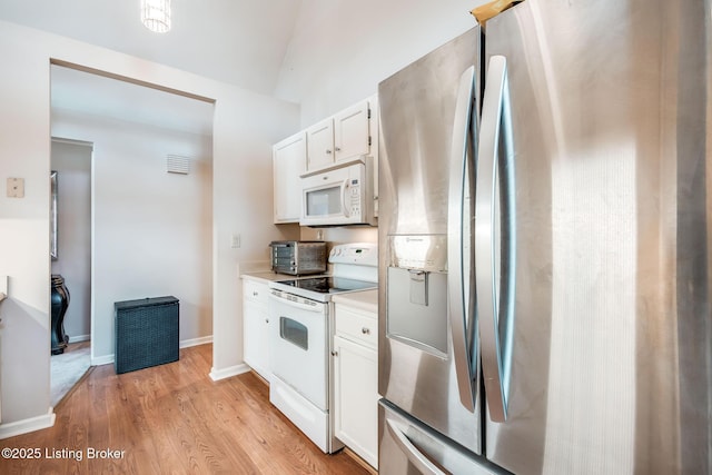 kitchen featuring white appliances, white cabinetry, and light wood-type flooring