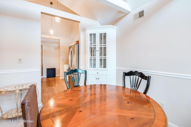 dining area featuring light hardwood / wood-style flooring and lofted ceiling