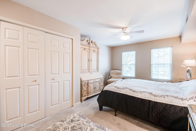 bedroom with ceiling fan and light carpet