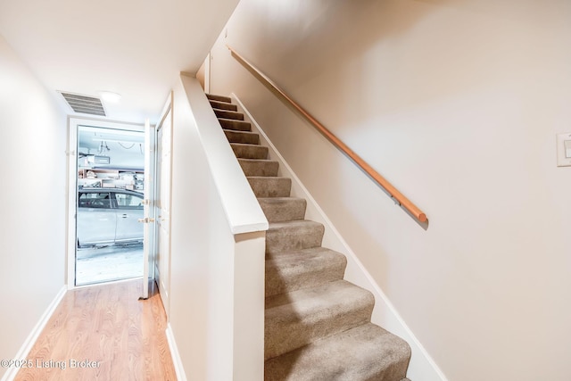 stairway featuring wood-type flooring