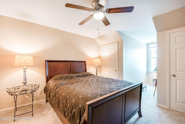 carpeted bedroom featuring ceiling fan and vaulted ceiling