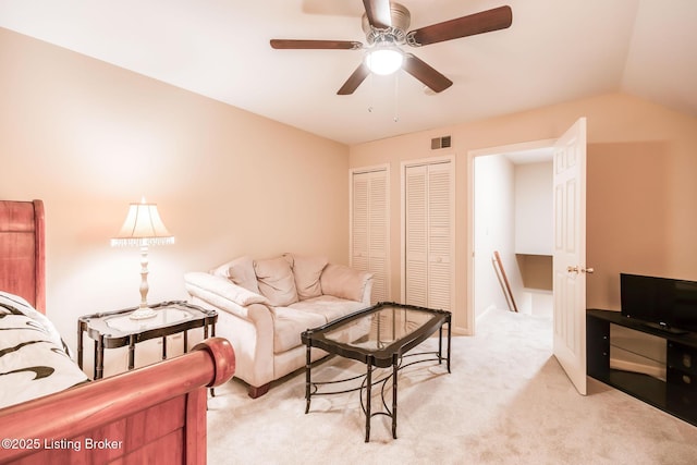 living room featuring ceiling fan, light colored carpet, and vaulted ceiling