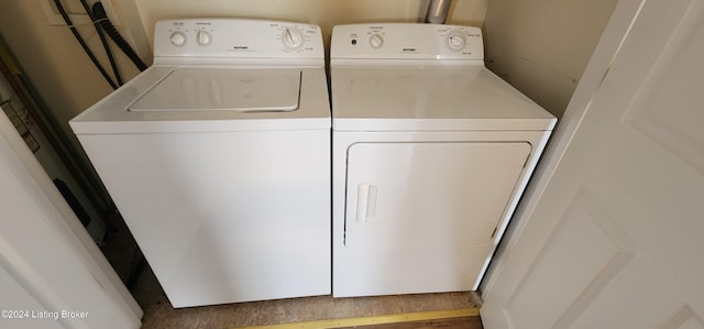 clothes washing area with washing machine and dryer