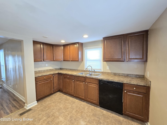 kitchen with black dishwasher, baseboards, visible vents, light countertops, and a sink