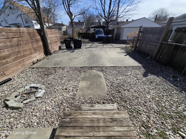 view of yard with a fenced backyard, a patio, and an outbuilding