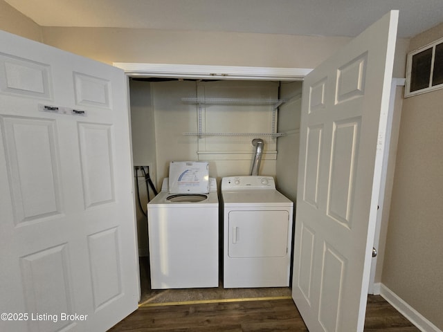 laundry room with baseboards, laundry area, dark wood-type flooring, and washer and dryer