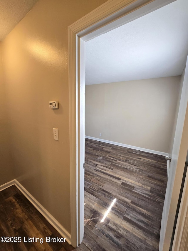 interior space with wood finished floors and baseboards