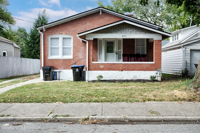 bungalow with a front lawn and a porch