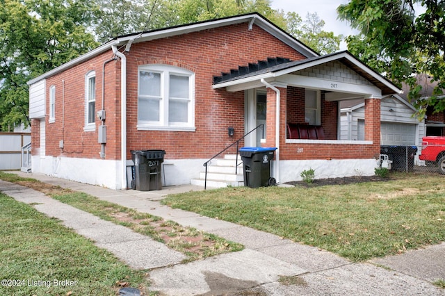 bungalow-style home featuring a front yard