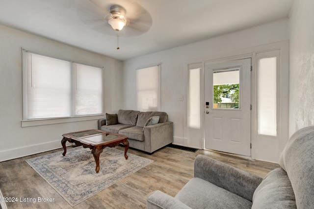 living room with light hardwood / wood-style floors and ceiling fan