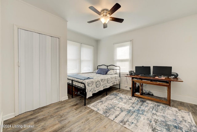 bedroom with ceiling fan and hardwood / wood-style floors