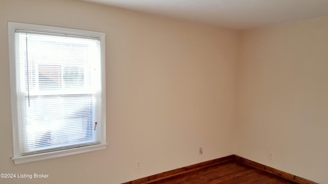 unfurnished room featuring dark hardwood / wood-style flooring