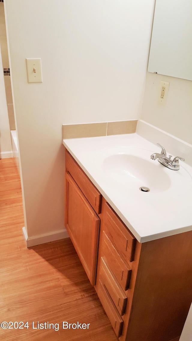 bathroom featuring vanity and hardwood / wood-style floors