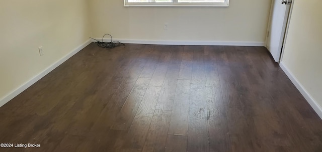 empty room featuring dark hardwood / wood-style flooring