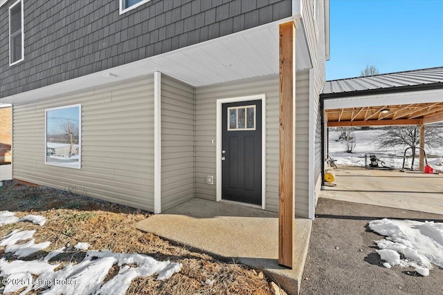 view of snow covered property entrance