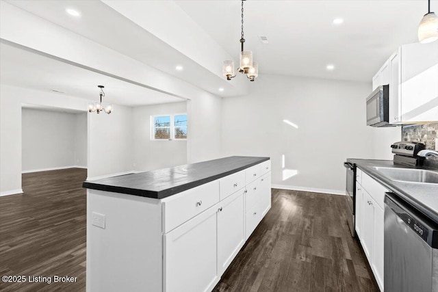 kitchen featuring white cabinetry, appliances with stainless steel finishes, and pendant lighting