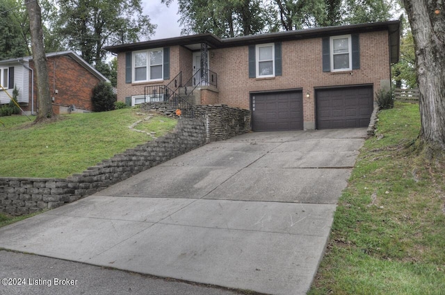 bi-level home with a garage and a front lawn