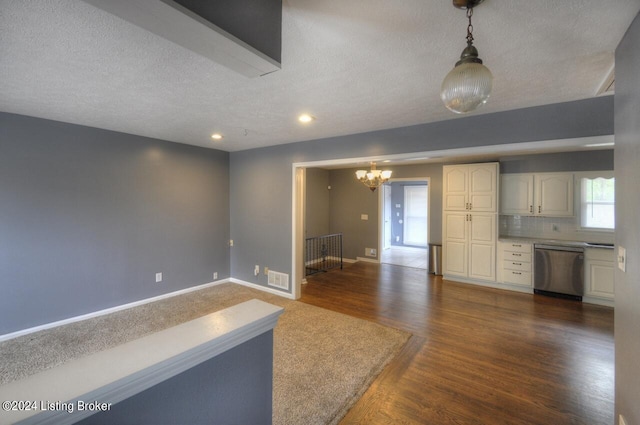 interior space featuring dark wood-type flooring, plenty of natural light, and a textured ceiling