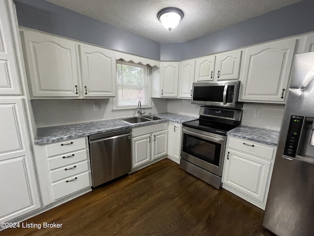 kitchen featuring sink, a textured ceiling, white cabinets, and stainless steel appliances