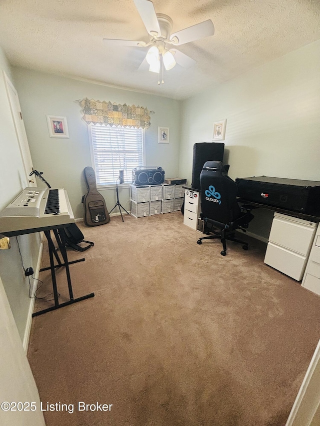 office area with ceiling fan, carpet, and a textured ceiling