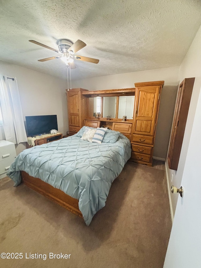 carpeted bedroom featuring a textured ceiling and ceiling fan