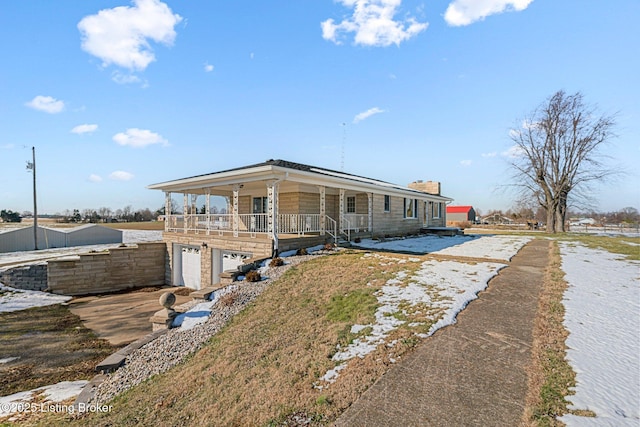 ranch-style house with a garage and covered porch