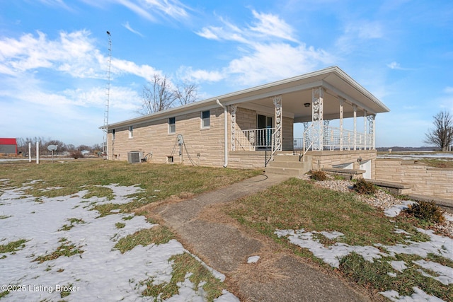 view of property exterior featuring central AC unit and a porch